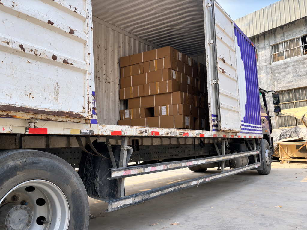 Loading cardboard boxes during the Ciciwood packing process.
